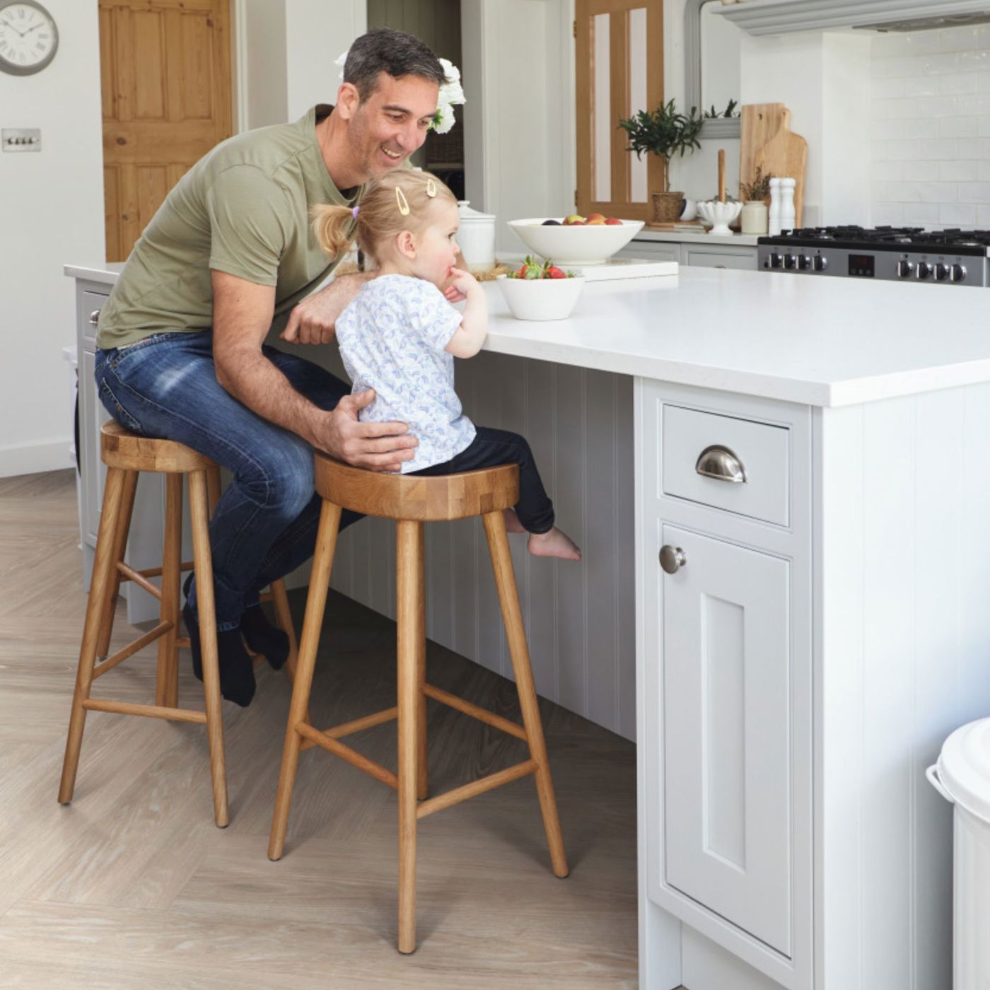 A man and his daughter in a chic dining area adorned with luxury vinyl