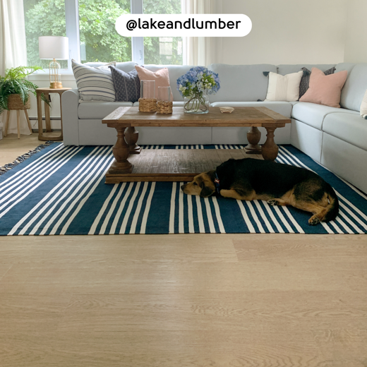 Dog resting on the Washed Butternut RKP8108 floors in a living room; photo credit: @lakeandlumber